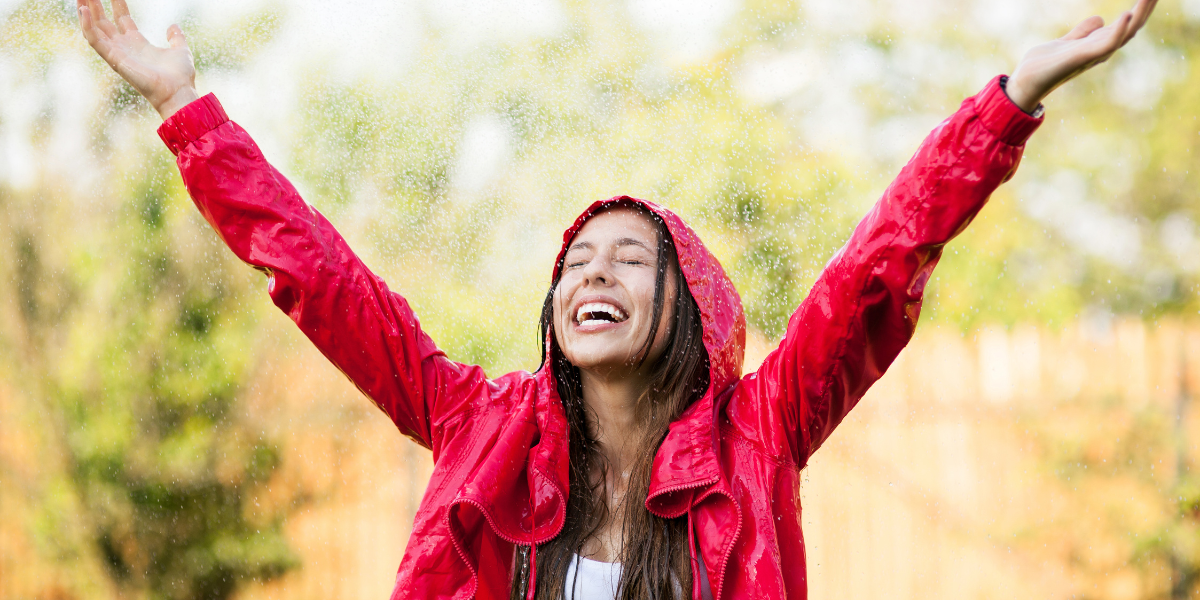 Red Water-Repellent Jacket Person wearing a red water-repellent jacket in outdoor rain